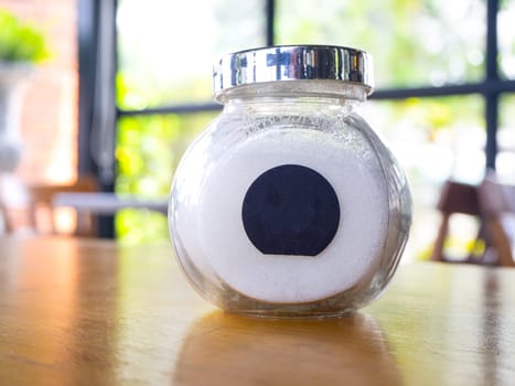 sugar in  glass jar on wood table for coffee.