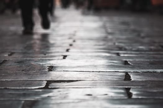 A selective focus shot of outdoor concrete block floor