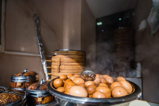 A view of freshly-boiled eggs with steam in a rural kitchen captured under the sunlight