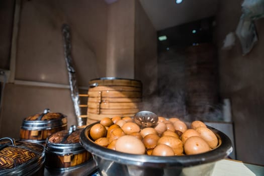 A view of freshly-boiled eggs with steam in a rural kitchen captured under the sunlight