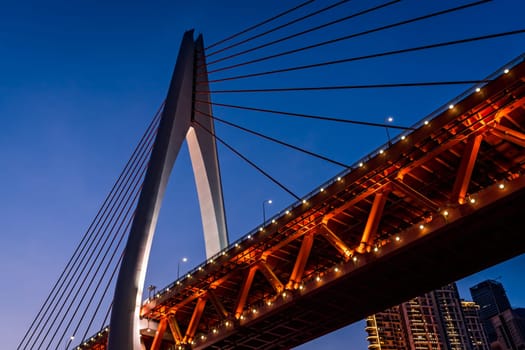 Low angle shot of an illuminated Twin River .cable stayed bridge in Chongqing, China