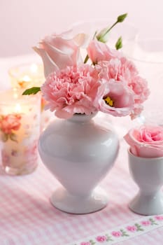 Beautiful bouquet in pink and white in vase on the kitchen table