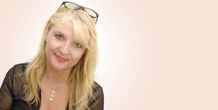 a portrait of mature smiling blond woman