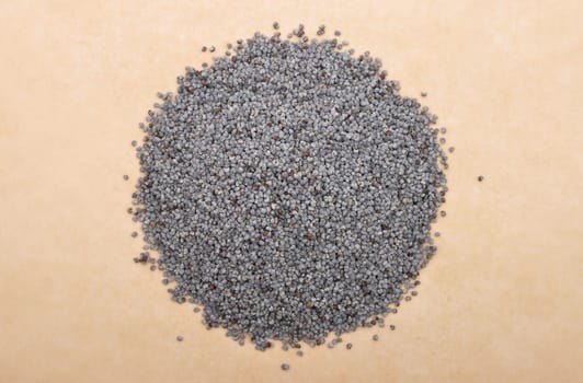 Poppy seeds on brown background