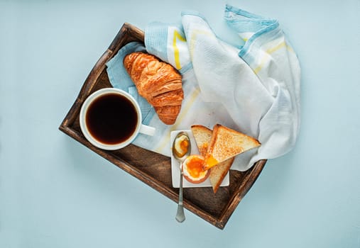 Continental Breakfast served with coffee, croissant, boiled egg and toast