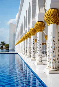 A colonnade and reflection pools in Sheikh Zayed Grand Mosque in Abu Dhabi, UAE