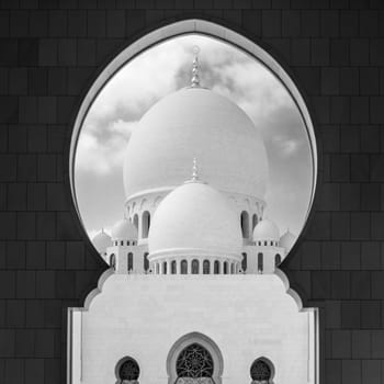 View of main dome of the Sheikh Zayed Grand Mosque framed by an arch. Abu Dhabi, UAE