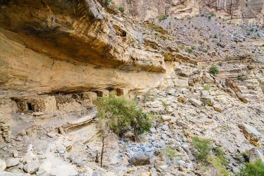 Ancient stone cliff dwellings in Wadi Ghul in Oman