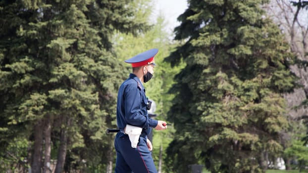Petropavlovsk, Kazakhstan - 29.04.2020: Kazakh police officer in a protective face mask during the period of quarantine for covid-19 coronavirus