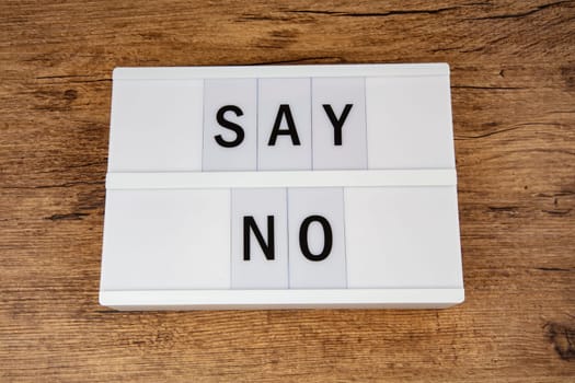 Concept SAY NO Letters on a lightbox on wooden background