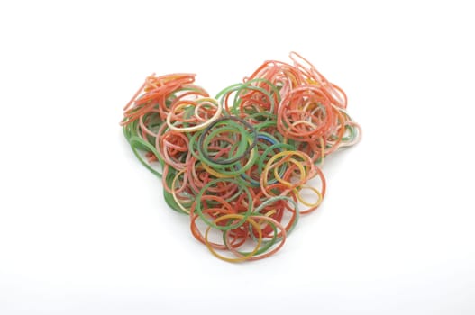 Colorful rubber bands for making rainbow loom bracelets in heart shape isolated on white background