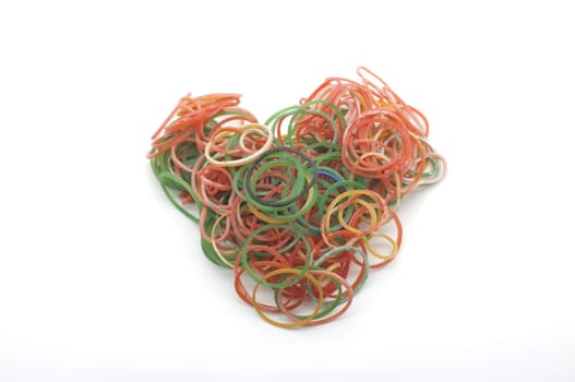 Colorful rubber bands for making rainbow loom bracelets in heart shape isolated on white background