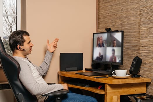 Middle age man talking on video conference with coworkers from comfort of his home during covid 19 or coronavirus pandemics, lockdown and quarantine
