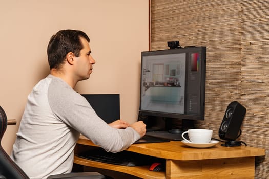Middle age man working on graphic tablet and computer from comfort of his home during covid 19 or coronavirus pandemics, lockdown and quarantine