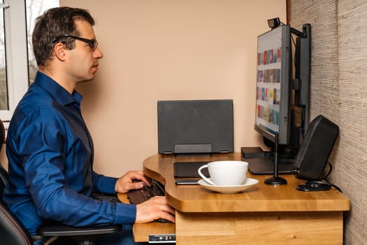 Middle age businessman working on computer from comfort of his home during covid 19 or coronavirus pandemics, lockdown and quarantine