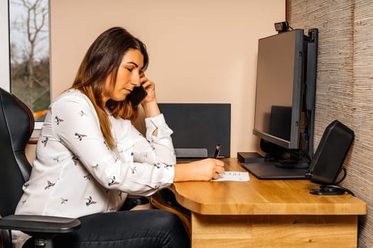 Businesswoman working on graphic tablet and computer from comfort of her home during covid 19 or coronavirus pandemics, lockdown and quarantine