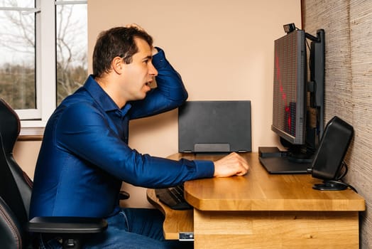 Middle age broken businessman in disbelief and shock, looking at stock market or his business as it crashes during covid 19 or coronavirus pandemics