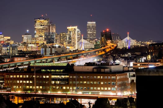 Night Boston Skycraper Skylines office downtown building with along Boston bay harbor at from Chelsea district. Boston is the capital city of the Commonwealth of Massachusetts in the United States