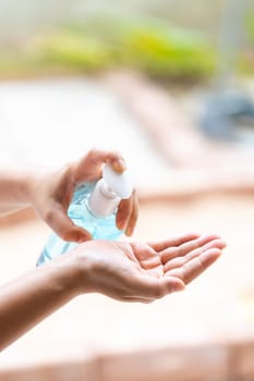 close-up cleaning hand using alocohol gel hand sanitizer waterless in pump bottle, disinfection for safety prevent and protect from infection of virus and germ Covid-19 coronavirus world pandemic.