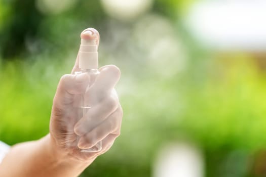 close-up Hand push on alocohol spray hand sanitizer bottle and spraying, disinfection for safety prevent and protect from infection of virus and germ Covid-19 coronavirus world pandemic.