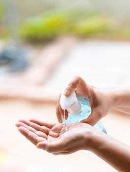 close-up cleaning hand using alocohol gel hand sanitizer waterless in pump bottle, disinfection for safety prevent and protect from infection of virus and germ Covid-19 coronavirus world pandemic.