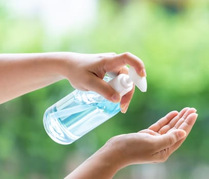 close-up cleaning hand using alocohol gel hand sanitizer waterless in pump bottle, disinfection for safety prevent and protect from infection of virus and germ Covid-19 coronavirus world pandemic.