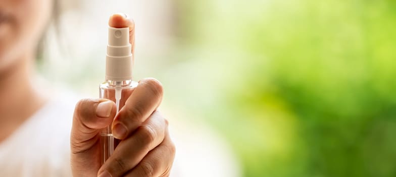 Panoramic close-up Hand push on alocohol spray hand sanitizer bottle and spraying, disinfection for safety prevent and protect from infection of virus and germ Covid-19 coronavirus world pandemic.