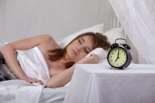 Portrait of beautiful young woman sleeping in bed at home.