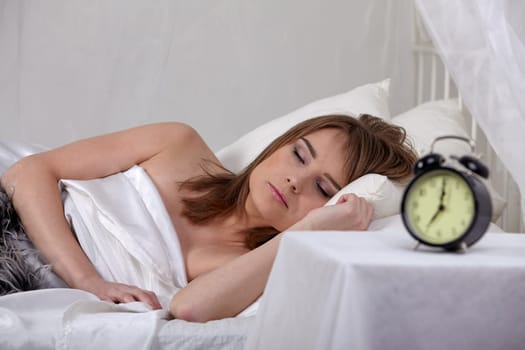 Portrait of beautiful young woman sleeping in bed at home.