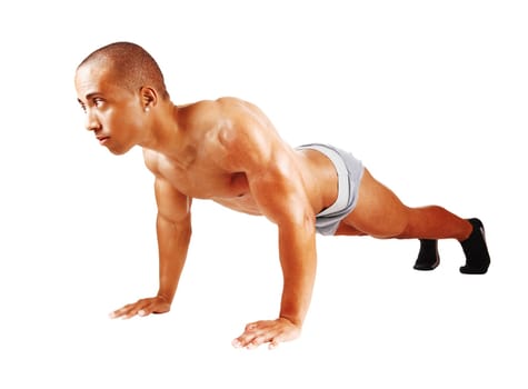 A handsome young man in gray underwear working out with push aps.on the floor in the studio, isolated for white background.