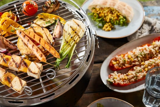 A close up of vegetables on a grill and various gourmet dishes.