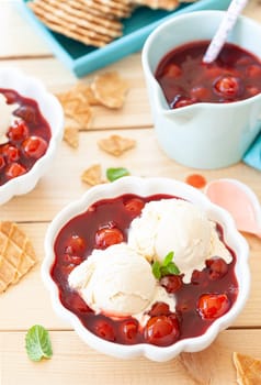 Scoops of vanilla ice cream with cherries and crunchy waffles