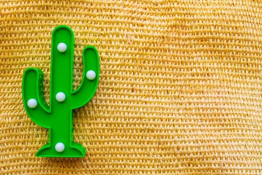 Cinco de Mayo background. A cactus on a straw rural bag background texture