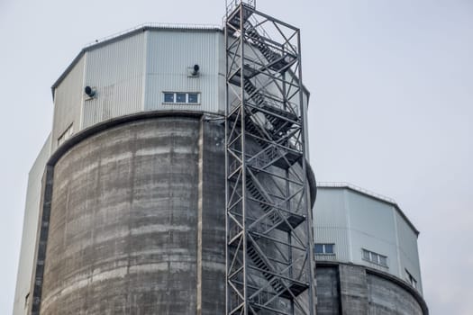 Staircase to the tower of a cement plant. Industry building.