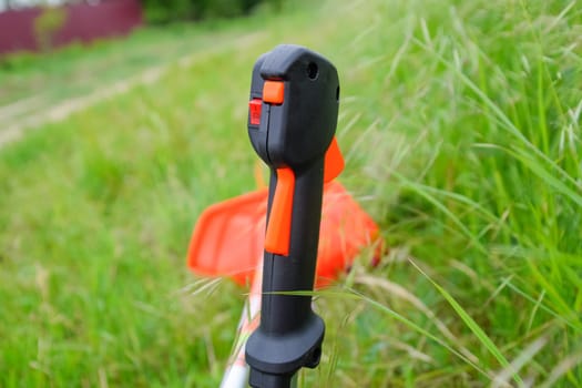 Knob with trimmer controls. Gas trimmer, equipment controls. Trimer gascosis with a leaf for mowing grass and shrubs.
