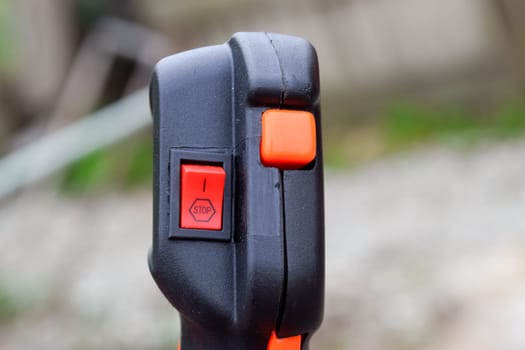 Knob with trimmer controls. Gas trimmer, equipment controls. Trimer gascosis with a leaf for mowing grass and shrubs.