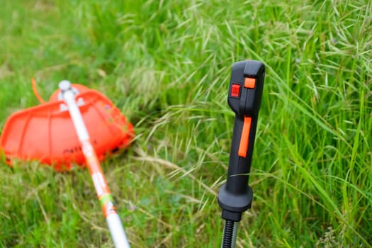 Knob with trimmer controls. Gas trimmer, equipment controls. Trimer gascosis with a leaf for mowing grass and shrubs.