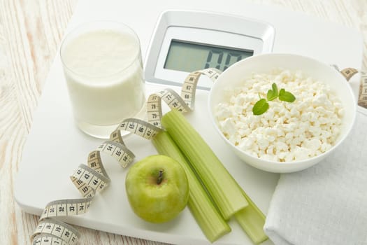 Slimming, diet, and control of weight. Still life with healthy food, scales and measuring tape. Healthy nutrition. Healthy lifestyle concept. Control of weight during the isolation period
