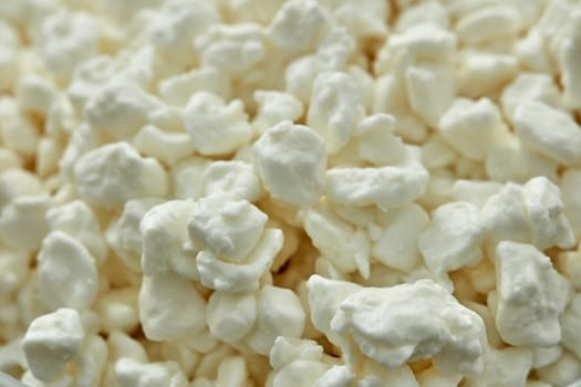 Background from fresh village cottage cheese. Healthy food. Close- up. Dietary product. Dairy product. Fitness food