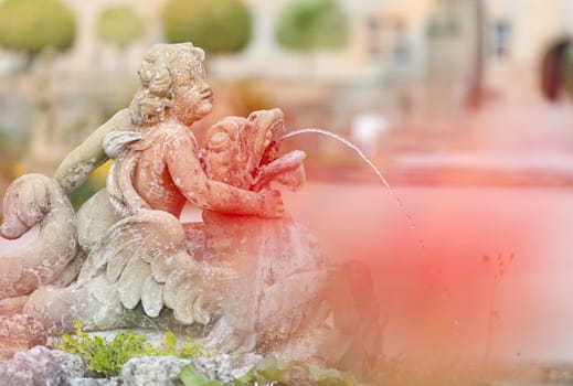 White statue of angel boy fountain in Weikersheim, Bavaria, Germany. Europe travel.