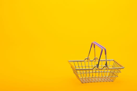Empty grocery basket on a bright orange background