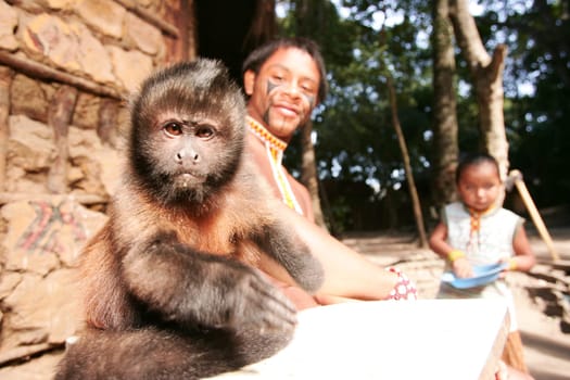 Porto Seguro, Bahia / Brazil - June 18, 2010: Pataxo Indians hold pet monkeys in Vila Jaquira in the city of Porto Seguro.