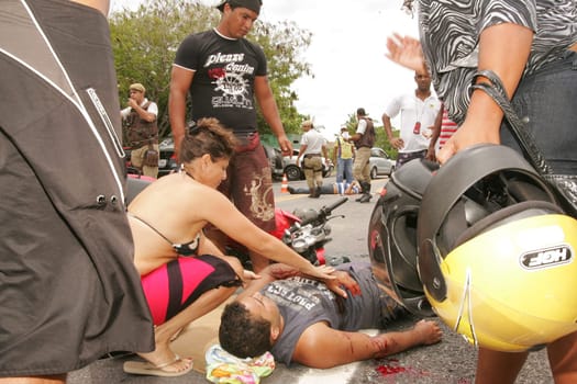 porto seguro, bahia / brazil - december 30, 2010: Samu rescuers service a motorcyclist involved in an accident on the BR 367 highway in Porto Seguro.