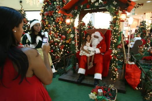 itabuna, bahia / brazil - december 5, 2011: Sitting on his throne Santa receives children at Shopping Jequitiba, in the city of Itabuna.