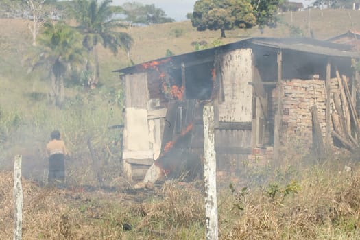 itabuna, bahia / brazil - may 2, 2012: Fire Department member fights insert focus on vegetation in the city of Itabuna.