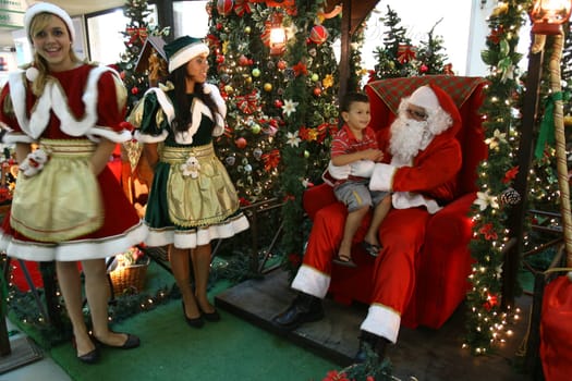 itabuna, bahia / brazil - december 5, 2011: Sitting on his throne Santa receives children at Shopping Jequitiba, in the city of Itabuna.