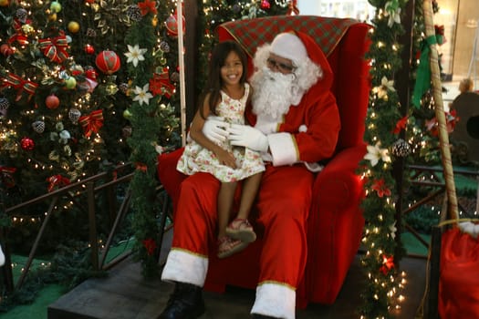 itabuna, bahia / brazil - december 5, 2011: Sitting on his throne Santa receives children at Shopping Jequitiba, in the city of Itabuna.