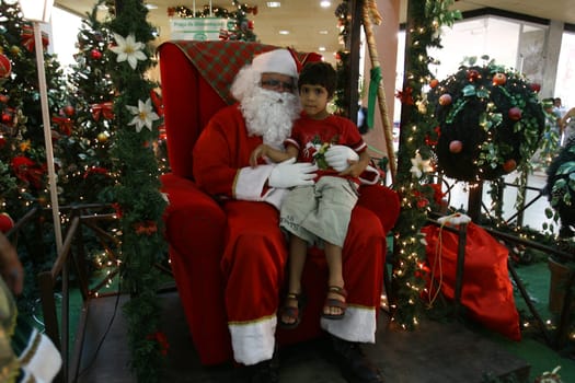 itabuna, bahia / brazil - december 5, 2011: Sitting on his throne Santa receives children at Shopping Jequitiba, in the city of Itabuna.
