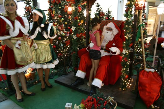itabuna, bahia / brazil - december 5, 2011: Sitting on his throne Santa receives children at Shopping Jequitiba, in the city of Itabuna.