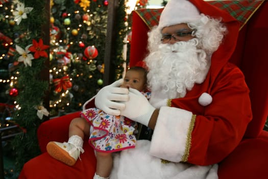 itabuna, bahia / brazil - december 5, 2011: Sitting on his throne Santa receives children at Shopping Jequitiba, in the city of Itabuna.